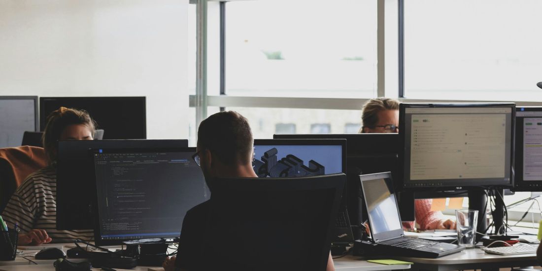 People working, coding at computers.