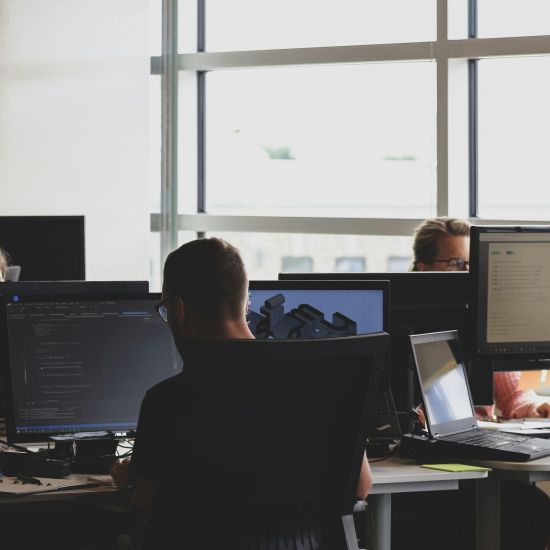 People working, coding at computers.