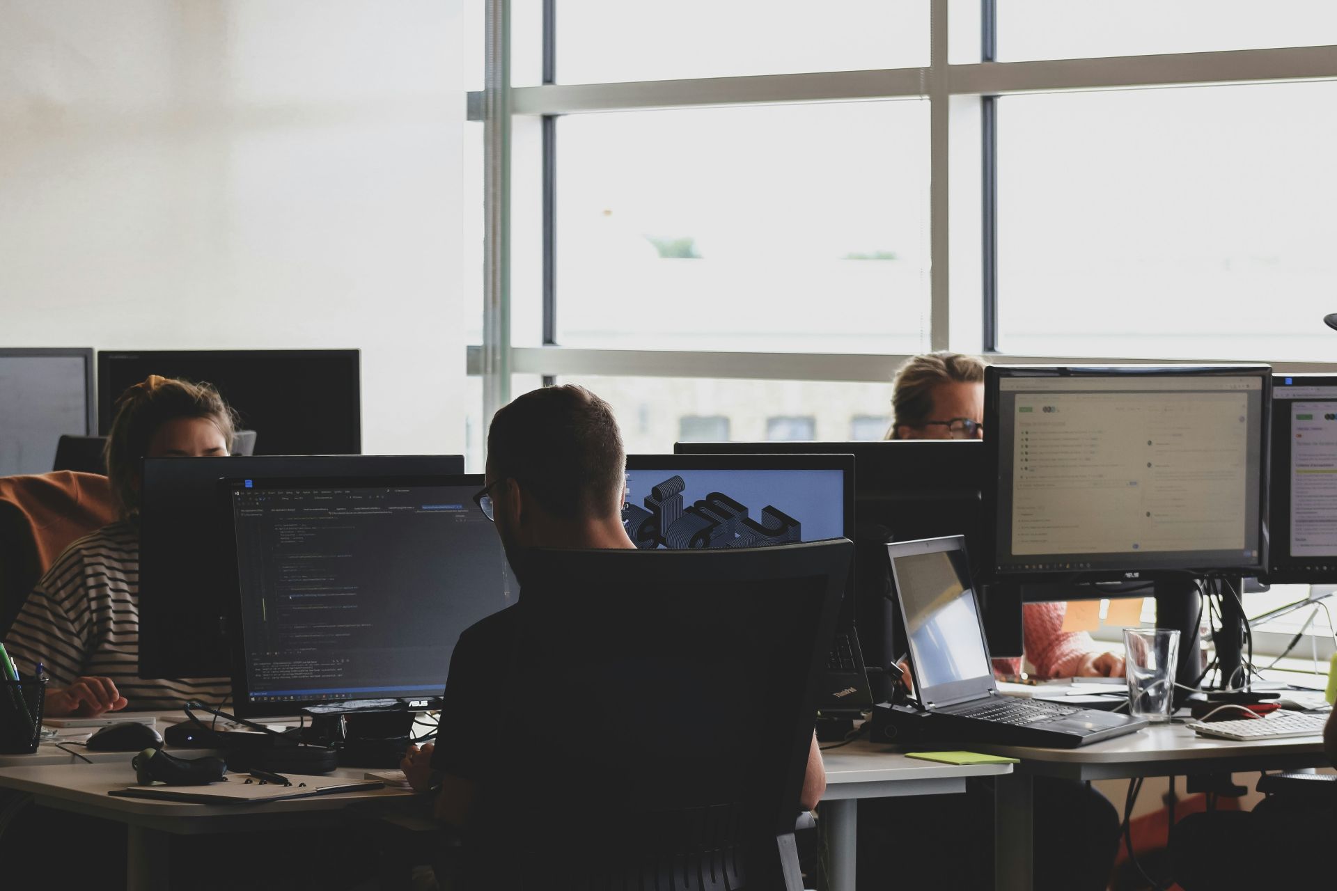 People working, coding at computers.